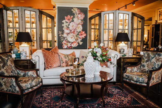 The juxtaposition between the traditional floral pattern on the accent chairs and the geometric coral cut velvet throw pillows is eye-catching and shows how dynamic the right fabric mix can be.