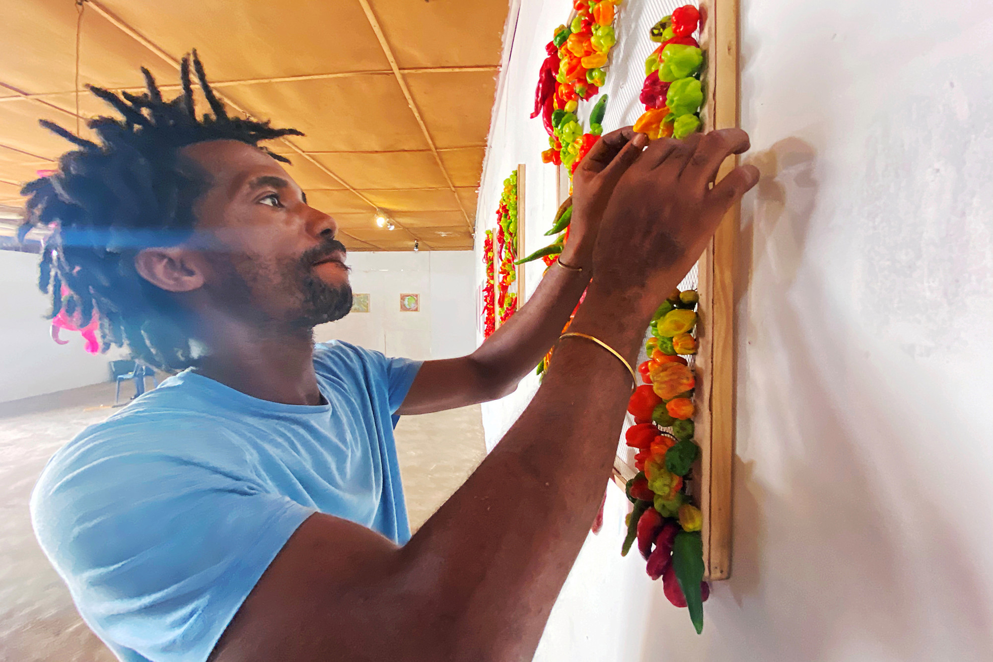 Nigerian artist Olufela Omokeko sets up an exhibition of fresh pepper motive at a gallery in Iwaya, Lagos