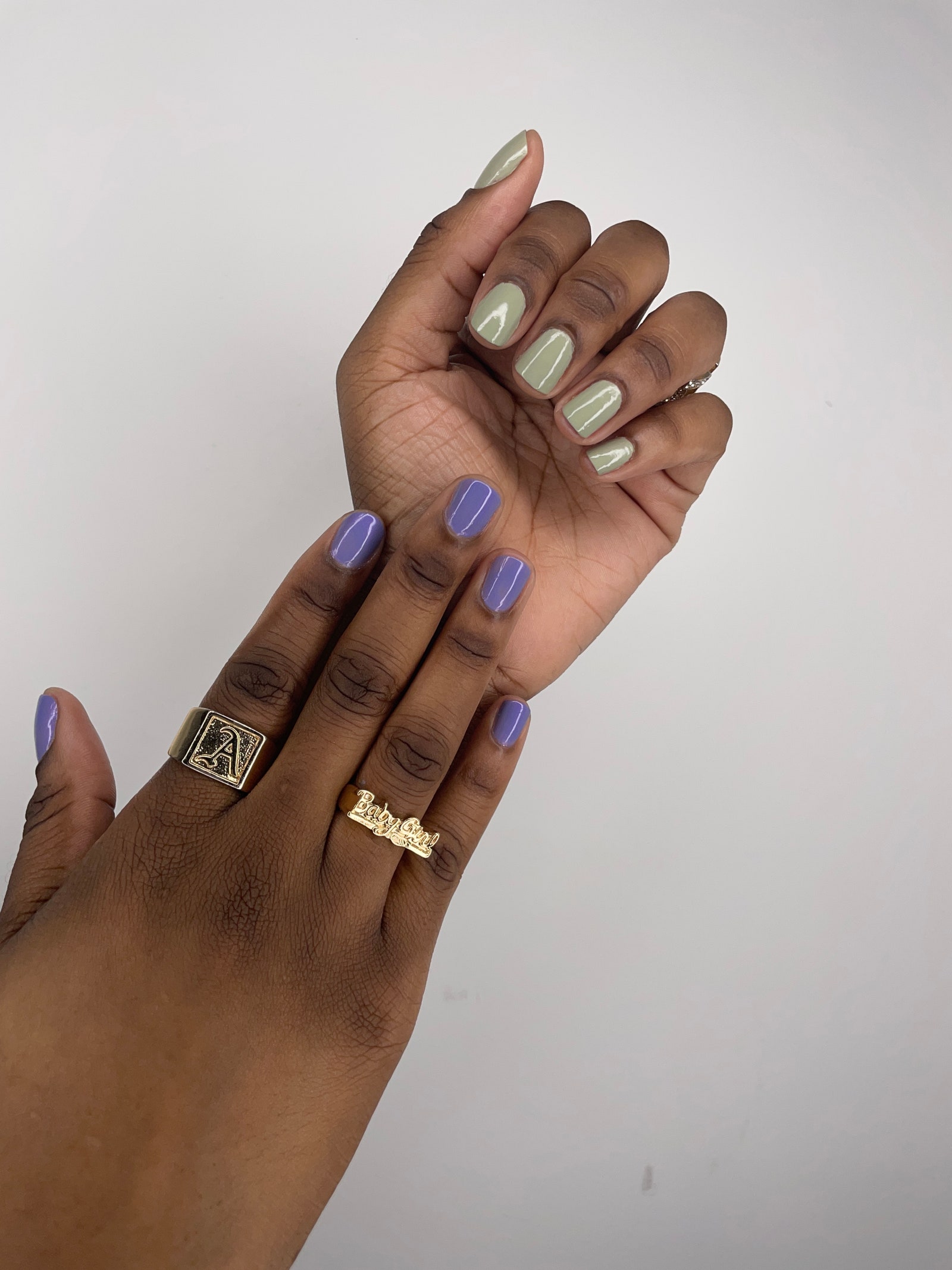 nailfie of Gabi Thorne's hands with a lavender polish on the left hand and minty green on the right