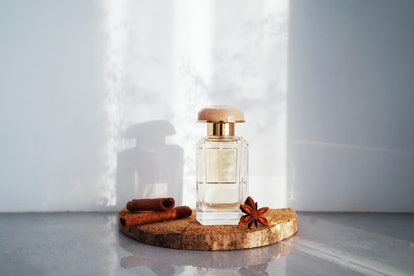  glass perfume bottle with fragments of wood bark, cinnamon sticks and anise stars with racy delica...