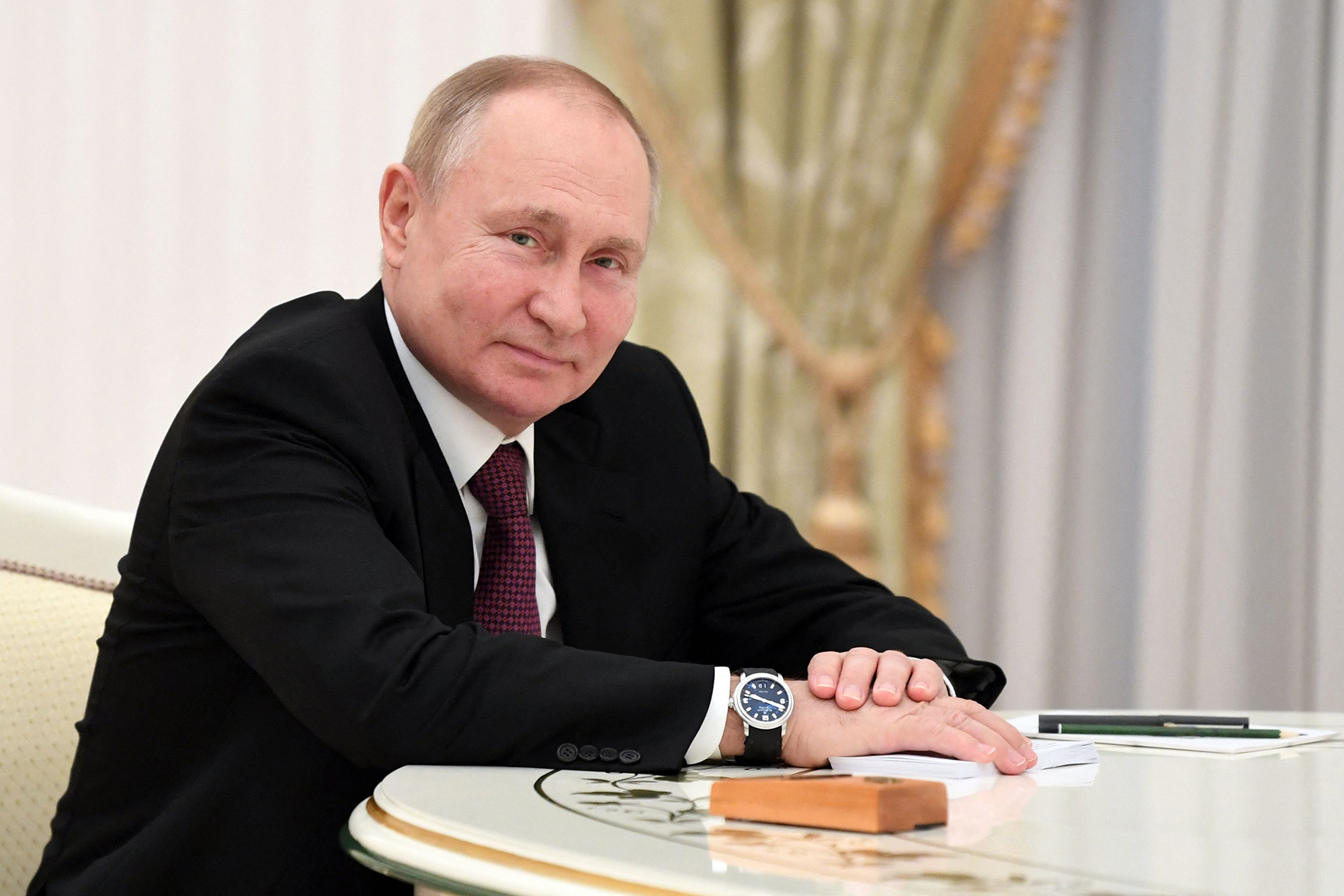 Russian President Vladimir Putin smiles during a meeting with Iranian President in Moscow on January 19, 2022. 