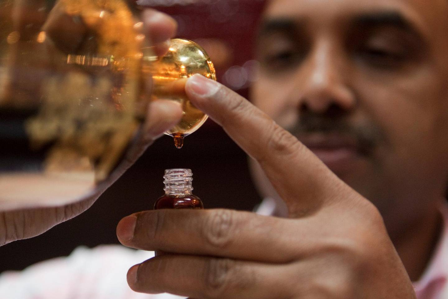 September 17, 2011 - A employee from Areej Al Ameerat perfume bottles perfume made of Oud into smaller bottles during the Abu Dhabi International Hunting and Equestrian exhibition in Abu Dhabi, UAE. Pawel Dwulit / The National