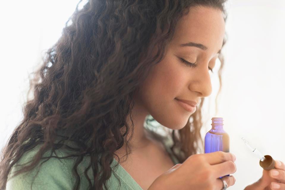Woman smelling essential oil.