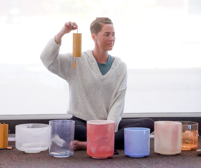 Facilitator Sarah Gardner leads a group sound bath session on Wednesday, July 13, 2022, at the Maven Space social an co-working club in Indianapolis. 