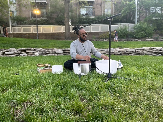 Devon Ginn, a 32-year-old sound bath mediation artist from Indianapolis, facilitating a sound bath at the canal during Canal Walk in 2022.