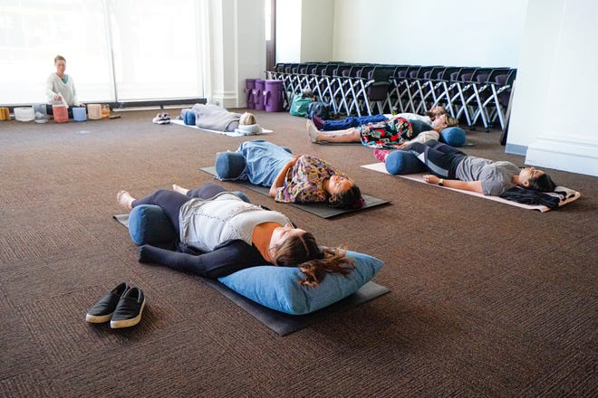 Facilitator Sarah Gardner, left, leads a group sound bath session on Wednesday, July 13, 2022, at the Maven Space social an co-working club in Indianapolis. 