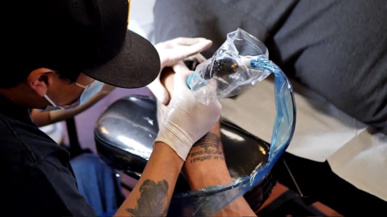 Contest participant Damien Basham getting a Farmer Boys Tattoo.