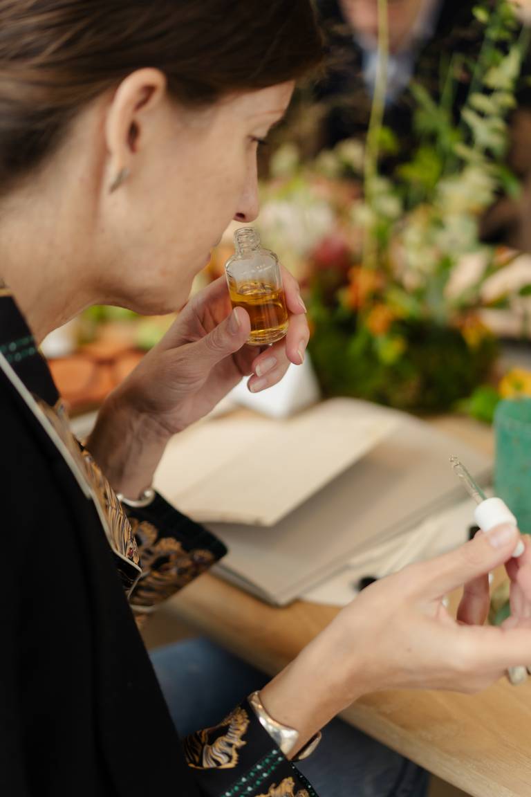 An attendee smells a fragrance sample at the Integra Fragrances x BoF workshop and event in Milan.